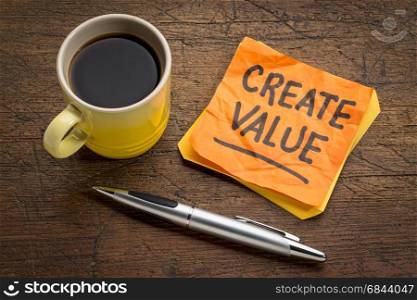 create value reminder or advice - inspiration concept - handwriting on a sticky note with a cup of coffee