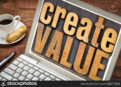 create value typography - inspiration concept - words in vintage letterpress wood type blocks on a laptop screen