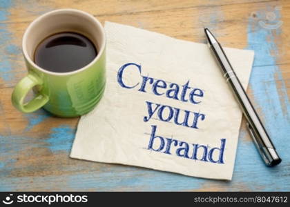 Create your brand advice - handwriting on a napkin with a cup of espresso coffee