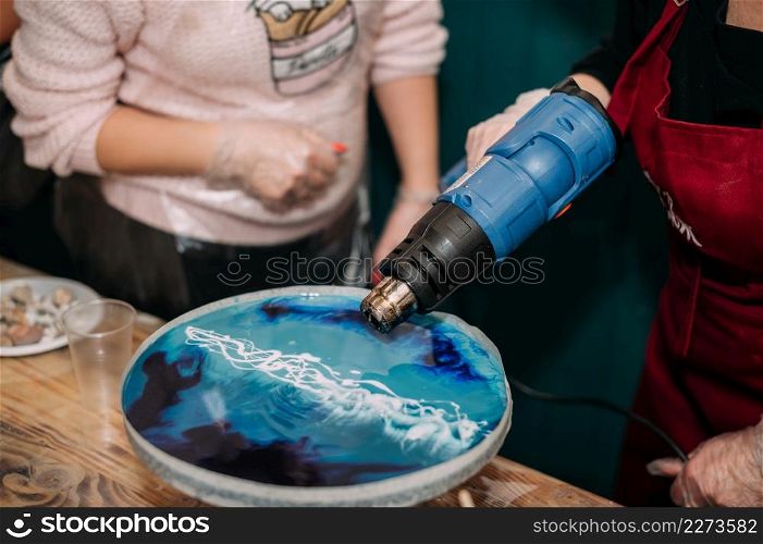 Creating a wave pattern in epoxy resin with a hair dryer.. The work of a hair dryer on epoxy resin creating waves 4298.