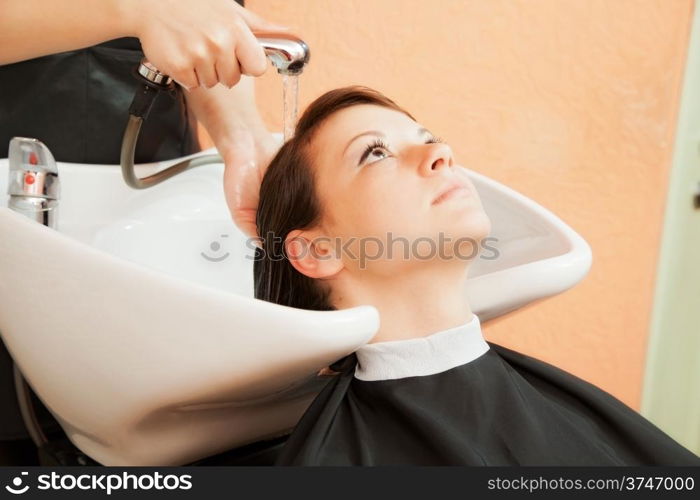 creating hairstyles hairdresser at salon. indoor shot