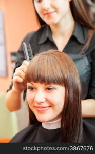 creating hairstyles hairdresser at salon. indoor shot