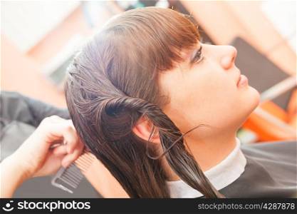 creating hairstyles hairdresser at salon. indoor shot