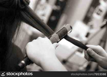 creating hairstyles hairdresser at salon. indoor shot