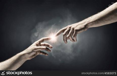 Creation concept. Close up of human hands touching with fingers
