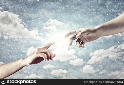 Creation concept. Close up of human hands touching with fingers