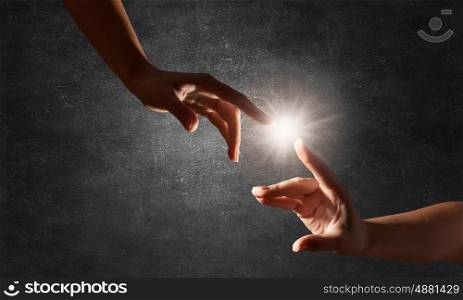 Creation concept. Close up of human hands touching with fingers