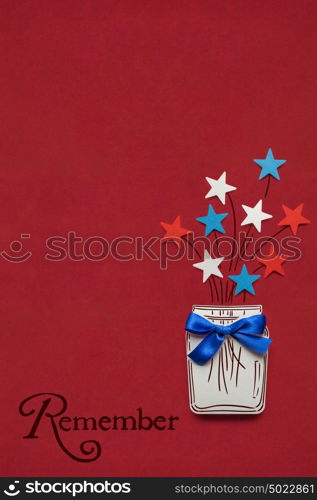 Creative 4th of July concept photo of stars in a bottle made of paper on red background.