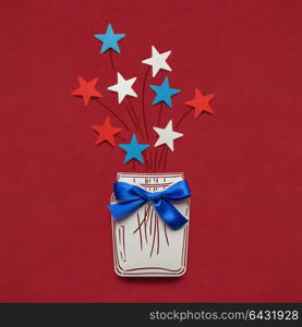 Creative 4th of July concept photo of stars in a bottle made of paper on red background.