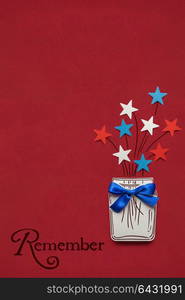 Creative 4th of July concept photo of stars in a bottle made of paper on red background.