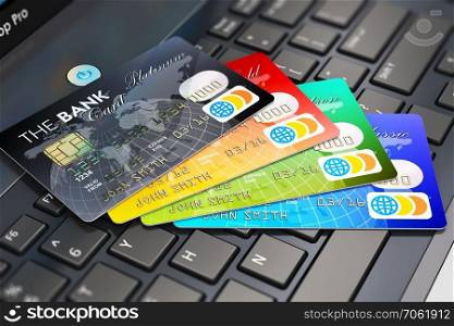 Creative abstract internet banking, accounting and online shopping web concept: macro view of group of color credit cards on laptop or notebook keyboard with selective focus effect