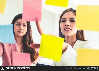 Creative Asian businesswoman in meeting workshop coming up with many positive ideas to help developing their corporate business. Group discussing and brainstorm concept.. Creative Asian businesswoman in meeting workshop.