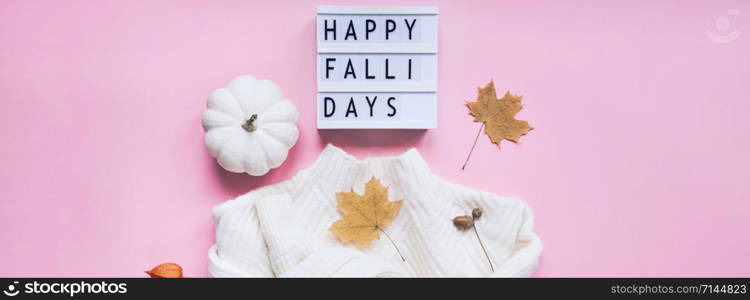 Creative autumn flat lay top view white cozy sweater pumpkin leaves lightbox Happy fallidays text on millennial pink background copy space minimal style Fall season composition for feminine blog