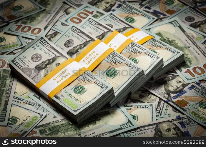 Creative business finance making money concept - background of new 100 US dollars 2013 edition banknotes bills bundles close up