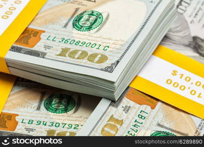 Creative business finance making money concept - background of of new 100 US dollars 2013 edition banknotes bills bundles close up