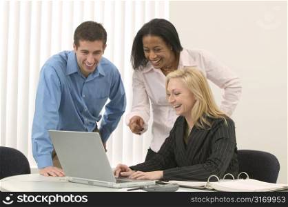 Creative Business Team Working With A Laptop Computer And Laughing