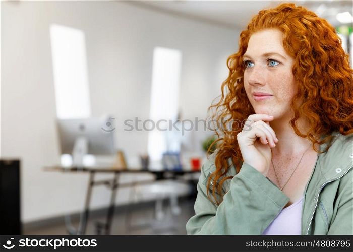 Creative business woman in office. Young and pretty business woman in office