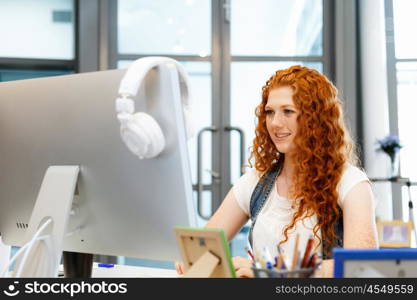 Creative business woman in office. Young and pretty business woman working in office