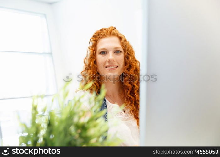 Creative business woman in office. Young and pretty business woman working in office