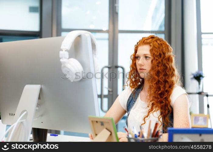 Creative business woman in office. Young and pretty business woman working in office