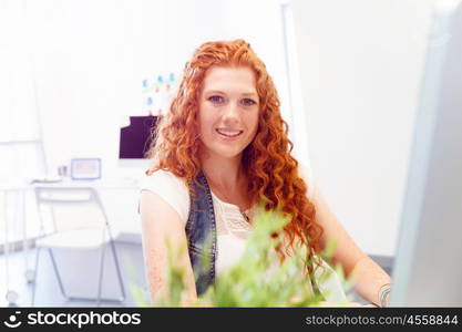 Creative business woman in office. Young and pretty business woman working in office