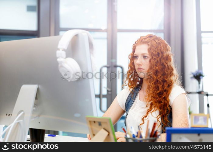 Creative business woman in office. Young and pretty business woman working in office