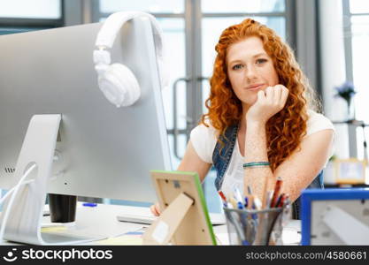 Creative business woman in office. Young and pretty business woman working in office