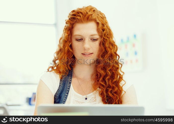 Creative business woman in office. Young and pretty business woman working in office