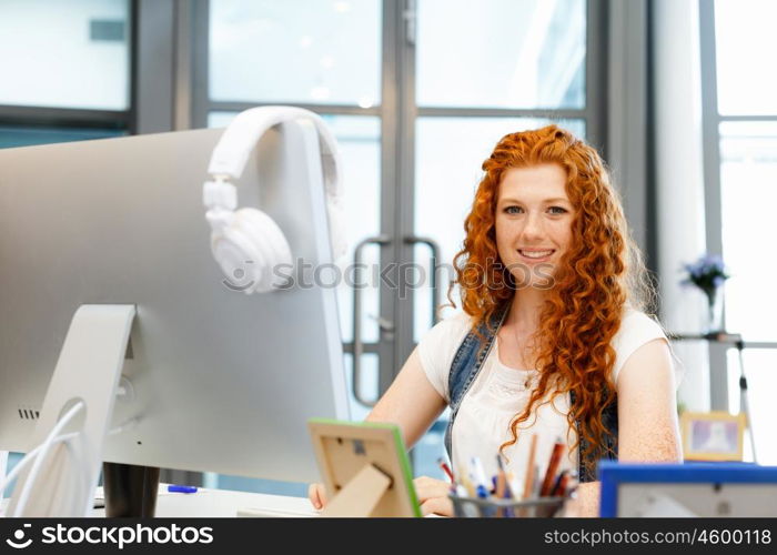 Creative business woman in office. Young and pretty business woman working in office