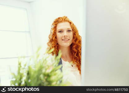 Creative business woman in office. Young and pretty business woman working in office