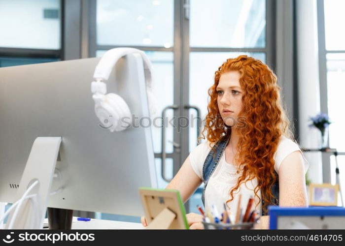 Creative business woman in office. Young and pretty business woman working in office