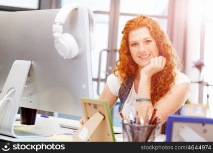 Creative business woman in office. Young and pretty business woman working in office