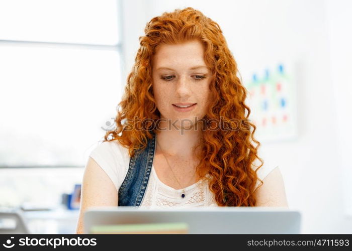 Creative business woman in office. Young and pretty business woman working in office