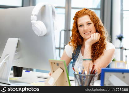 Creative business woman in office. Young and pretty business woman working in office