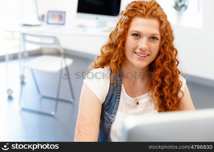 Creative business woman in office. Young and pretty business woman working in office