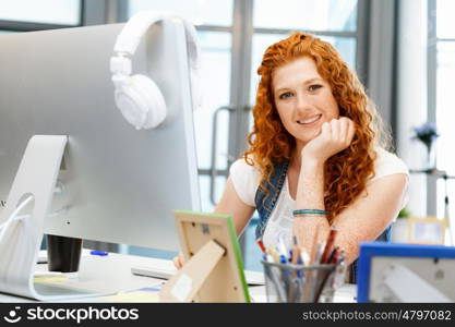 Creative business woman in office. Young and pretty business woman working in office