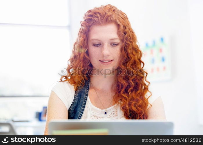 Creative business woman in office. Young and pretty business woman working in office