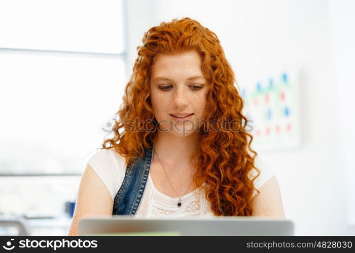 Creative business woman in office. Young and pretty business woman working in office