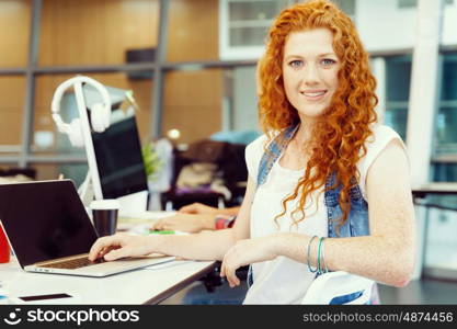 Creative business woman in office. Young and pretty business woman working in office