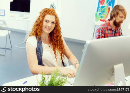 Creative business woman in office. Young and pretty business woman working in office