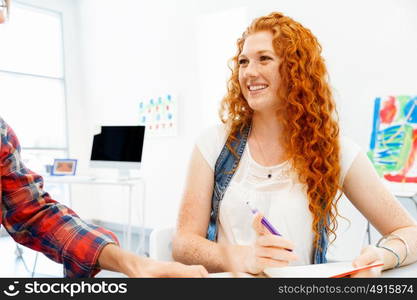 Creative business woman in office. Young and pretty business woman working in office