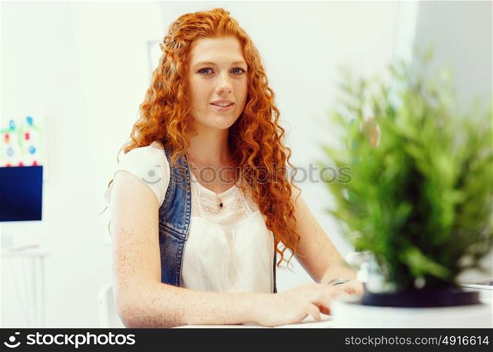 Creative business woman in office. Young and pretty business woman working in office