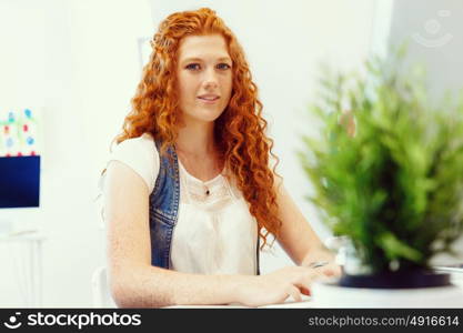 Creative business woman in office. Young and pretty business woman working in office