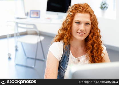 Creative business woman in office. Young and pretty business woman working in office