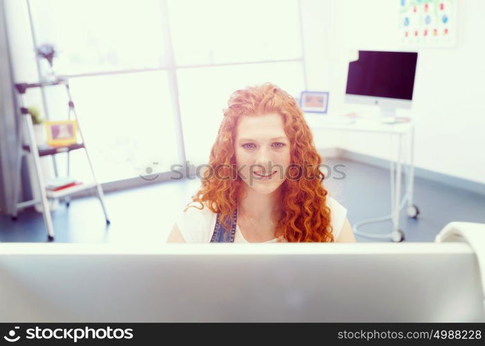 Creative business woman in office. Young and pretty business woman working in office