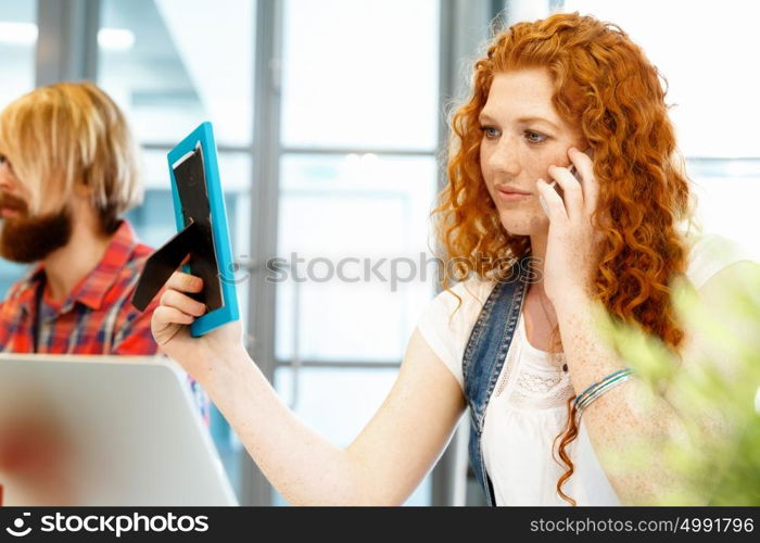 Creative business woman in office. Young and pretty business woman working in office