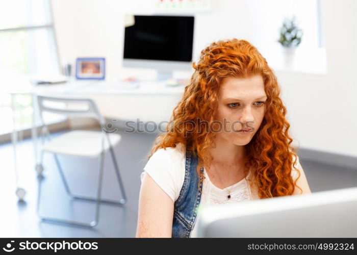 Creative business woman in office. Young and pretty business woman working in office