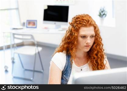 Creative business woman in office. Young and pretty business woman working in office