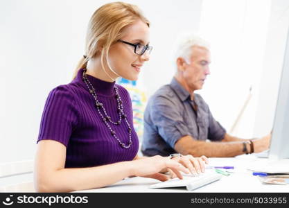 Creative business woman in office. Young and pretty business woman working in office