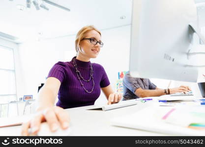 Creative business woman in office. Young and pretty business woman working in office